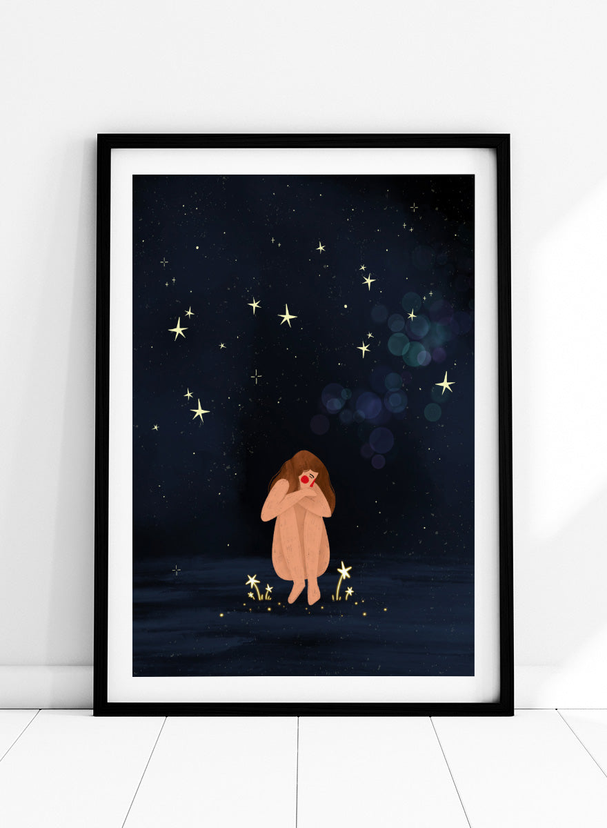A framed art print featuring a whimsical illustration of a girl sitting on a dark blue starry night sky. Shop Starlit Solitude by Bea Müller, a figurative wall art print poster featuring a solitary woman beneath a star-filled night sky in deep blue tones.