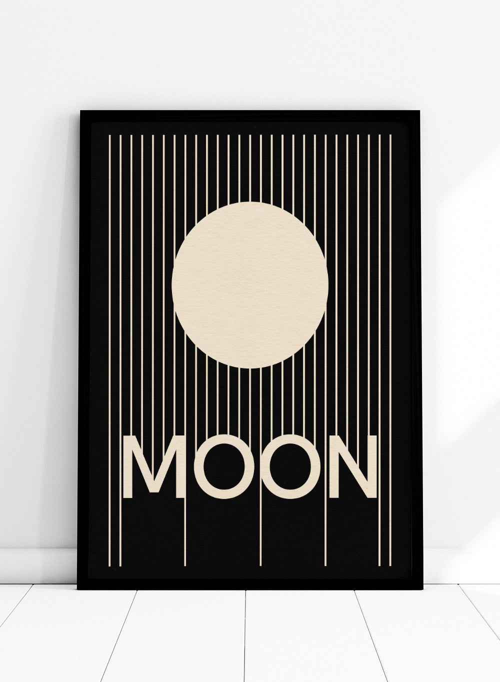 Poster with a stylized moon and the word 'MOON' on a black background. Moon by Rosi Feist is a bold minimalist Bauhaus-inspired art print with a cream circle and graphic lines. Officially licensed modern poster with framing.