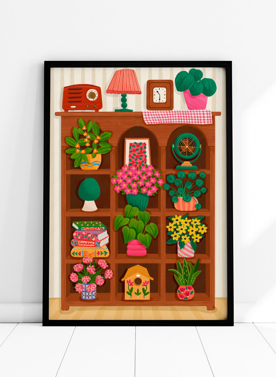 A colorful cartoon-style illustration of a wooden bookshelf filled with potted plants, flowers, books, a lamp, a clock, a radio, and other home decor items, set against a striped wall. Shop Cozy Botanical Shelf by Nidhi Kachhadiya, a colorful botanical wall art print featuring houseplants, flowers, vintage decor, and warm green and pink tones.