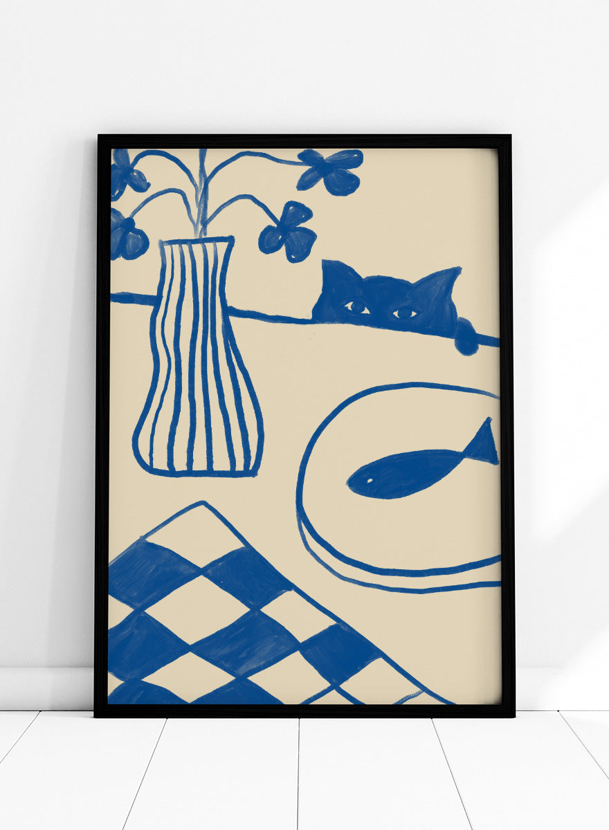 A framed art print featuring a hand-drawn style illustration in blue ink on a warm cream background. The design includes a striped vase with flowers, a cat peeking over a line, a fish on a plate, and a harlequin check pattern in the lower left corner. Blue Cat And Fish by The Art Concept is a playful cat art print featuring a curious blue cat, fish plate, striped vase, flowers, and checkered tablecloth.