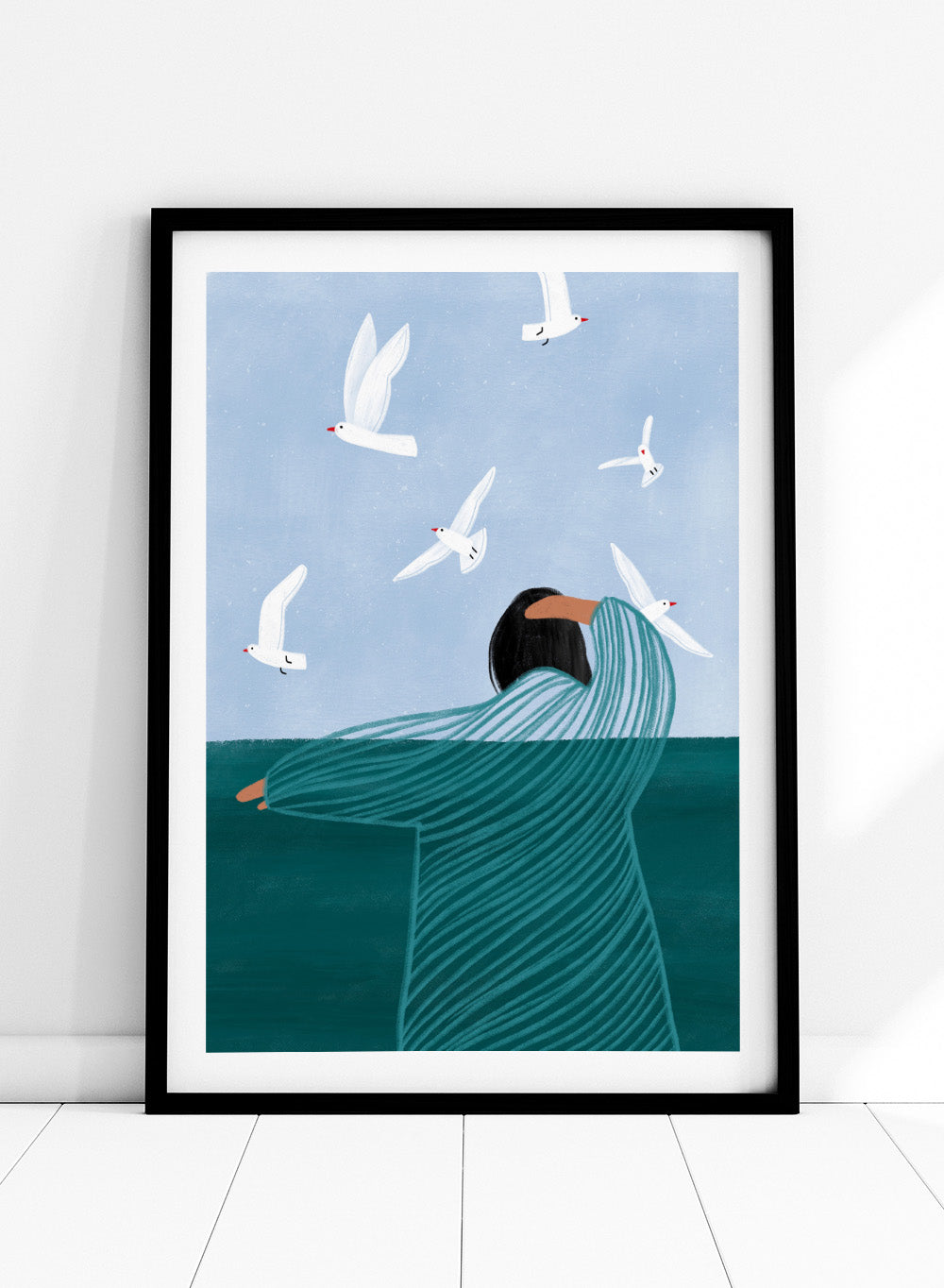Seaside Serenity by Bea Müller is an officially licensed art print featuring a calm seaside figure and flying birds. Available as fine art print or framed with real wood frames.