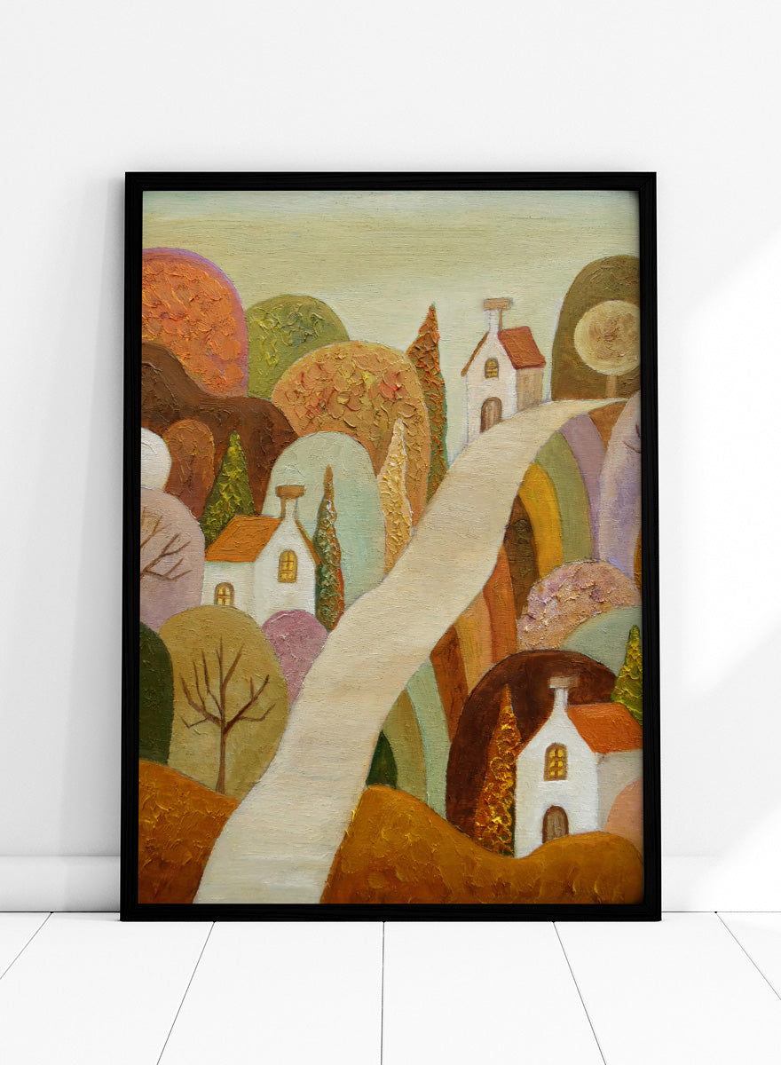 A stylized landscape painting featuring small white houses with orange roofs, rolling hills in earthy tones, and a pale winding path through the scene. Shop Whimsical Village Path by Angeles M. Pomata, an autumn landscape art print featuring a winding road, white village houses, rounded hills, and warm earthy tones.