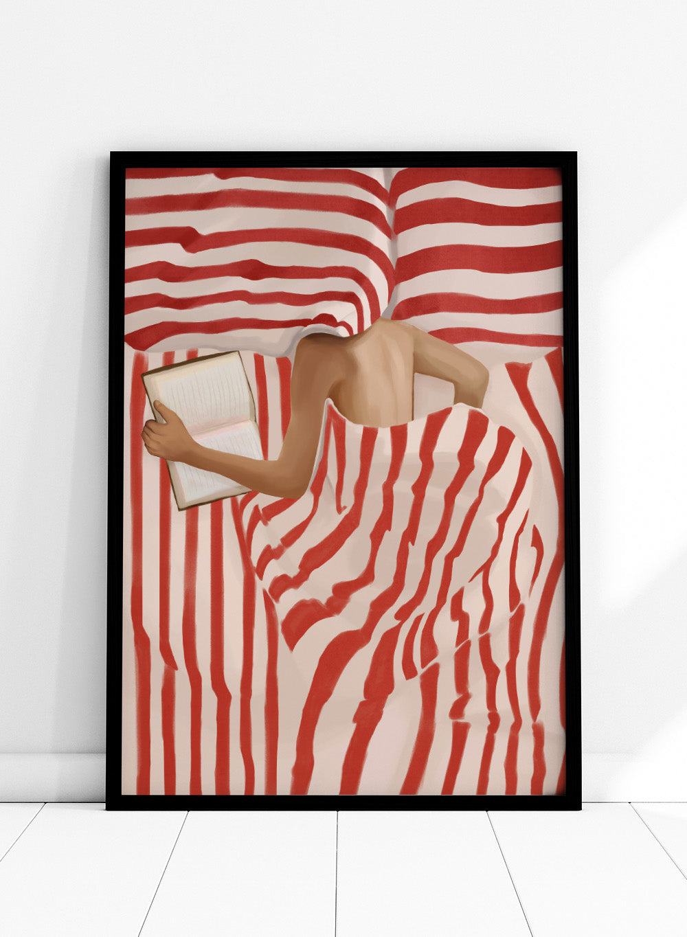 Between the Lines by Flow Line art print shows a woman reading in bed wrapped in red striped bedding. A modern lifestyle wall poster inspired by slow evenings.
