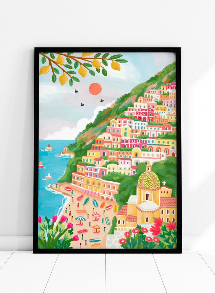 A colorful illustration of a coastal hillside town with tiered pastel buildings, a beach, blue sea, green foliage, and a church dome. Shop Vibrant Seaside Town by Nidhi Kachhadiya, a colorful coastal wall art print inspired by an Italian cliffside village, beach views, and bright Mediterranean color.