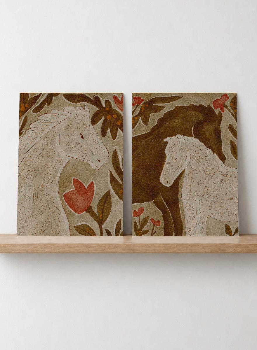 Two framed art prints depicting stylized horses in warm earthy tones. Shop Wildflower Horses by Nikita Jariwala, a set of 2 horse wall art prints posters featuring floral horse portraits, botanical details, and warm brown tones.