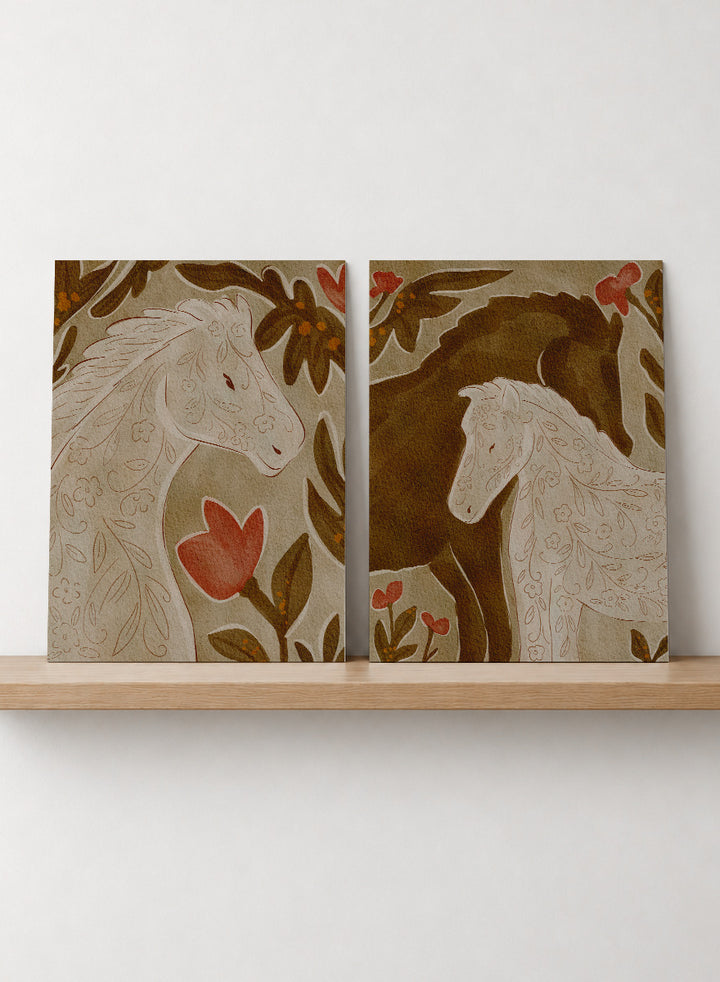 Two framed art prints depicting stylized horses in warm earthy tones. Shop Wildflower Horses by Nikita Jariwala, a set of 2 horse wall art prints posters featuring floral horse portraits, botanical details, and warm brown tones.