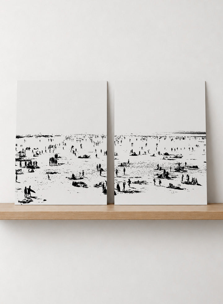 Shop Beach No.02 by Dan Hobday, a set of 2 black and white beach wall art prints posters featuring a panoramic shoreline filled with tiny figures.