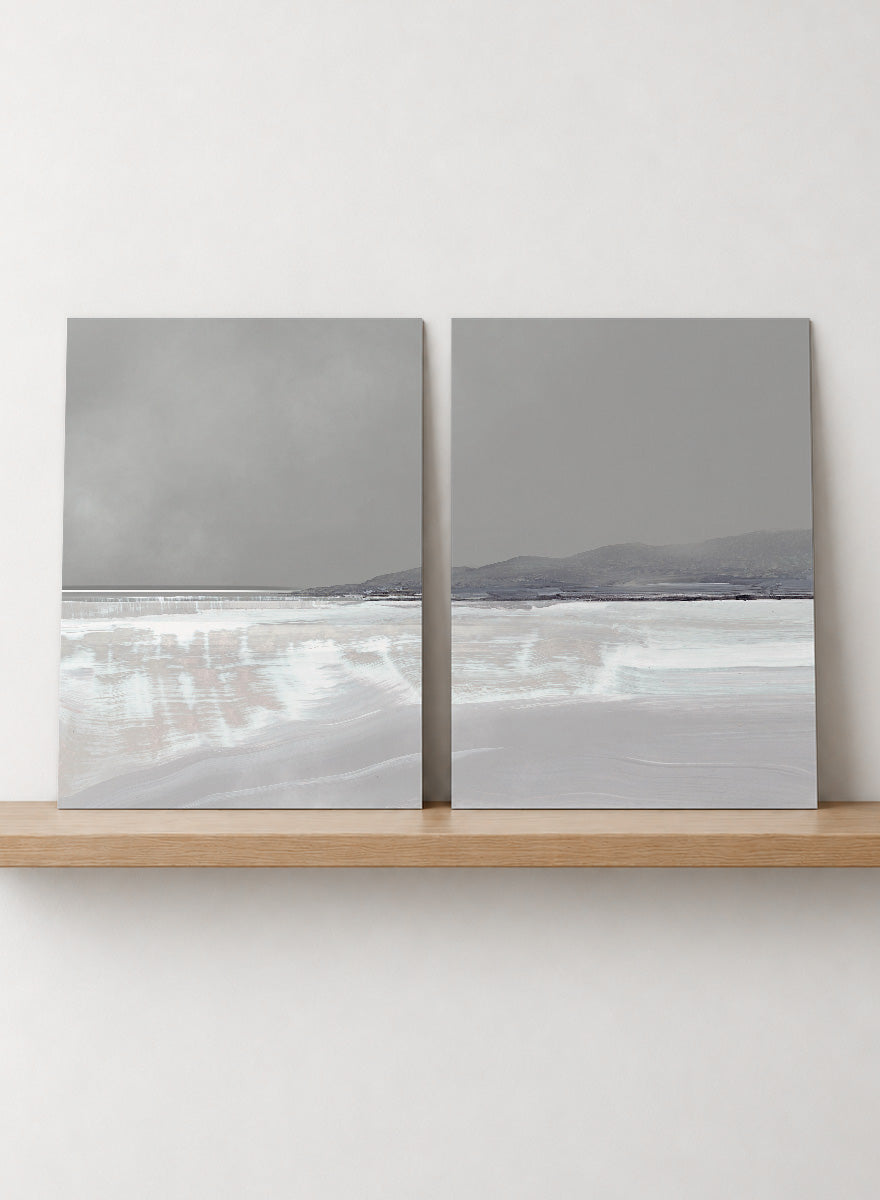 Shop Tides by Dan Hobday, a set of 2 coastal landscape wall art prints posters featuring calm water, distant hills, and soft gray-blue tones.