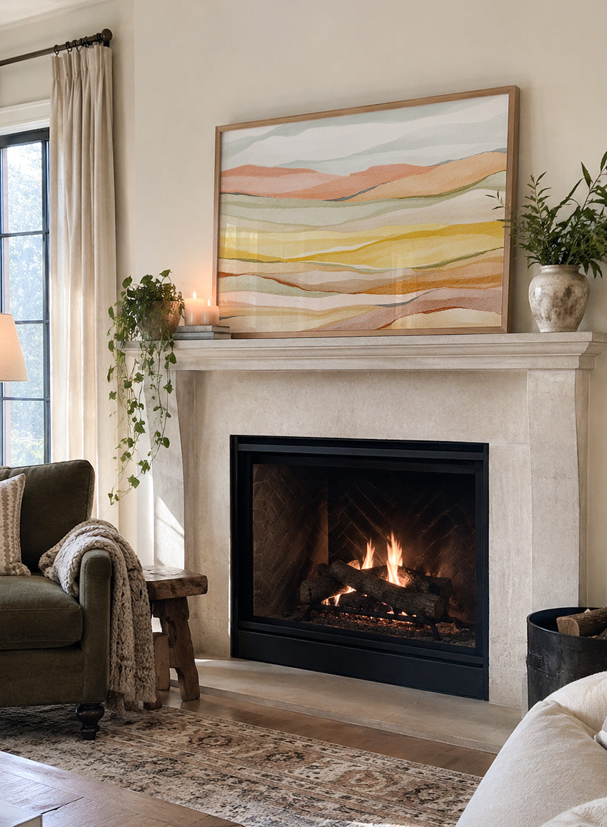 Framed abstract landscape wall art featuring layered wavy hills in soft peach, yellow, beige, and muted green tones. Shop Warm Horizon Layers by Nikita Jariwala, an abstract landscape wall art print poster with layered hills and mountains, soft yellow fields, and warm peach tones.