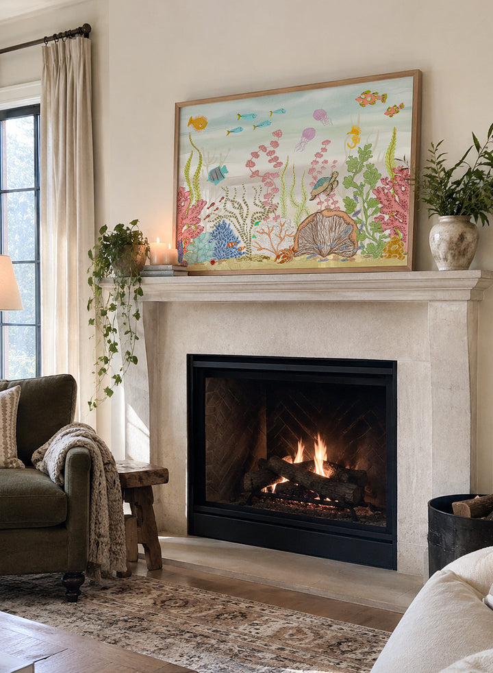 A framed art print depicting a colorful underwater scene with fish, coral, sea plants, a turtle, and a clam shell on a sandy ocean floor, shown against a light neutral background. Shop Vibrant Underwater World by Nikita Jariwala, an ocean wall art print poster with sea turtles, tropical fish, coral reef art, jellyfish, and blue tones.