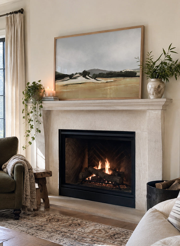 Shop Lazy Afternoon by Dan Hobday, a warm landscape art print featuring golden fields, dark trees, rolling hills, and soft late-summer tones.
