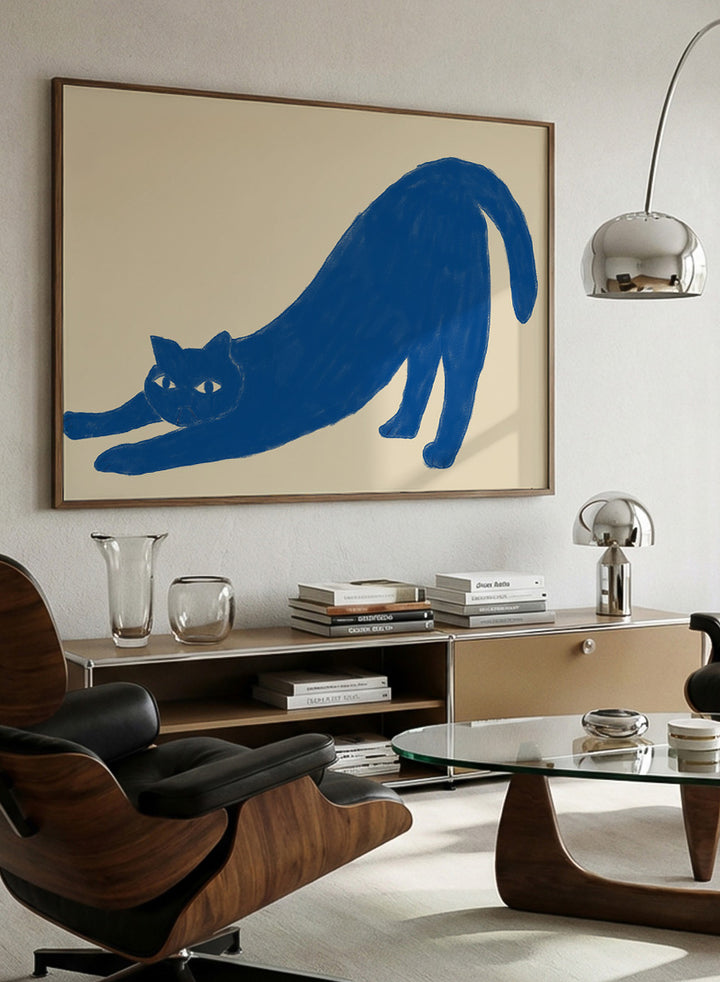 Framed wall art featuring a blue cat stretching on a beige background. Stretching Blue Cat by The Art Concept is a playful cat art print featuring a blue stretching cat on a warm cream background in a simple modern style.