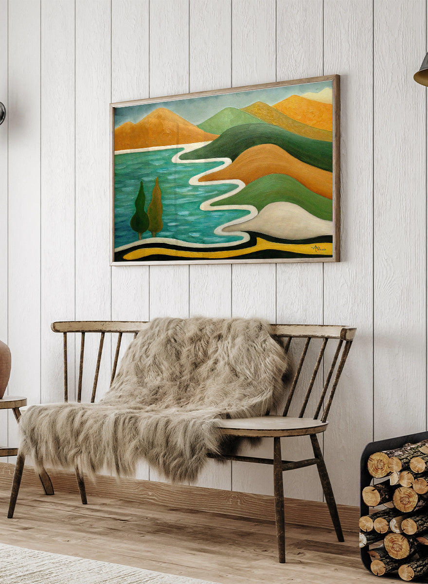 A framed landscape painting featuring stylized green hills, orange mountains, a winding white path, and a turquoise blue body of water with two dark green trees. Shop Abstract River Landscape by Angeles M. Pomata, a colorful abstract landscape art print featuring winding water, rolling hills, and bold earthy tones.