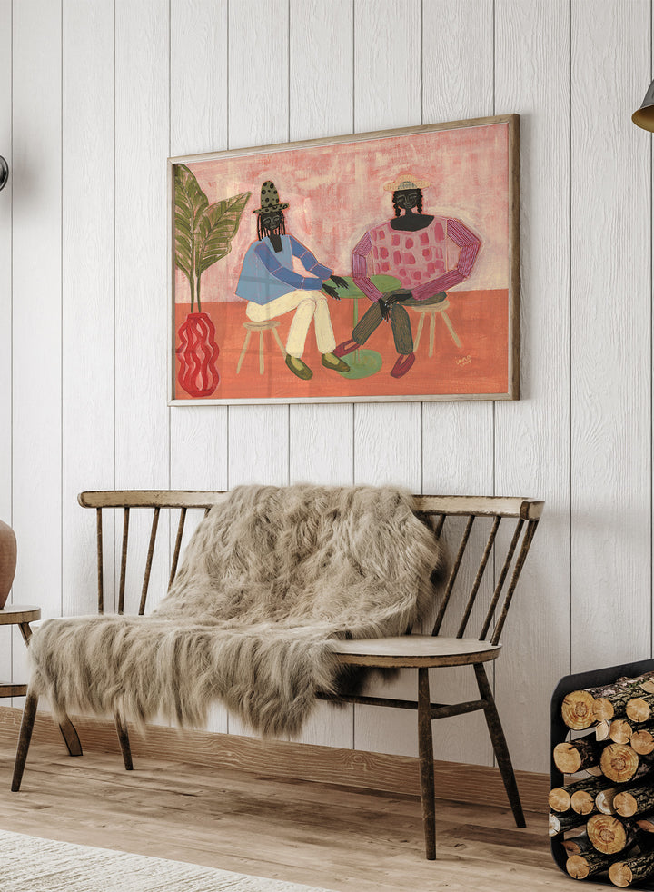 Artistic depiction of two people sitting on chairs with a plant and vase in the foreground, on a pink background. With a Friend by Studio IMO (Ibi Meier-Oruitemeka) is a modern figurative art print with two figures at a table in a contemporary wall poster design.