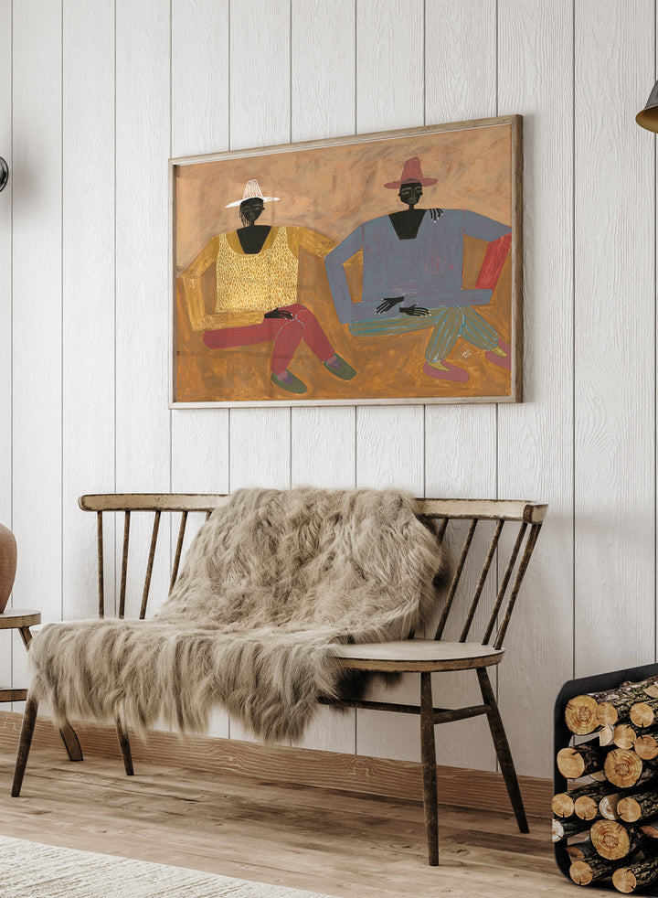 Framed artwork of two people sitting on a bench with a plain background. Still, Together by Studio IMO (Ibi Meier-Oruitemeka) is a modern figurative art print with two seated figures in a contemporary wall poster design.