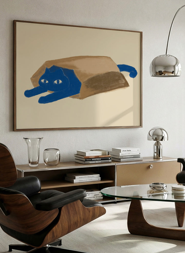 A framed art print featuring a whimsical illustration of a blue cat peeking out from inside a brown paper bag, set against a warm beige background. Blue Cat In A Bag by The Art Concept is a playful minimalist cat art print featuring a blue cat tucked inside a paper bag on a warm cream background.