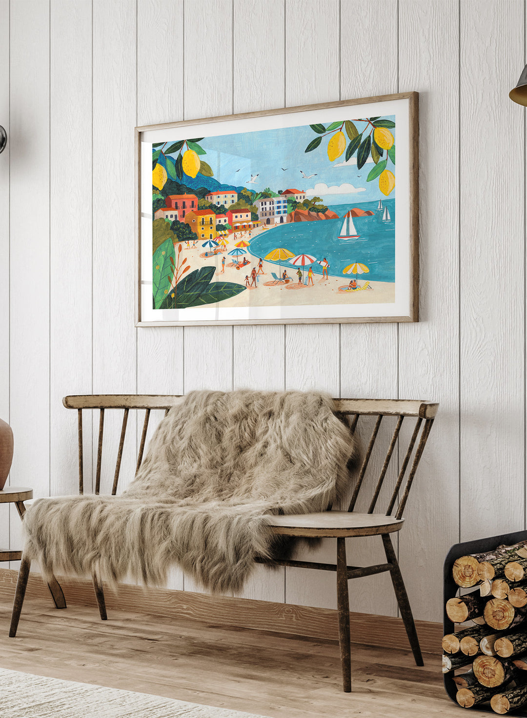 Framed artwork of a beach scene with people, umbrellas, and sailboats. Sunny Lemon Coastal Town by Caroline Bonne Müller is a colorful coastal art print featuring beach scene, seaside town, lemon branches, and modern aesthetic summer illustration.