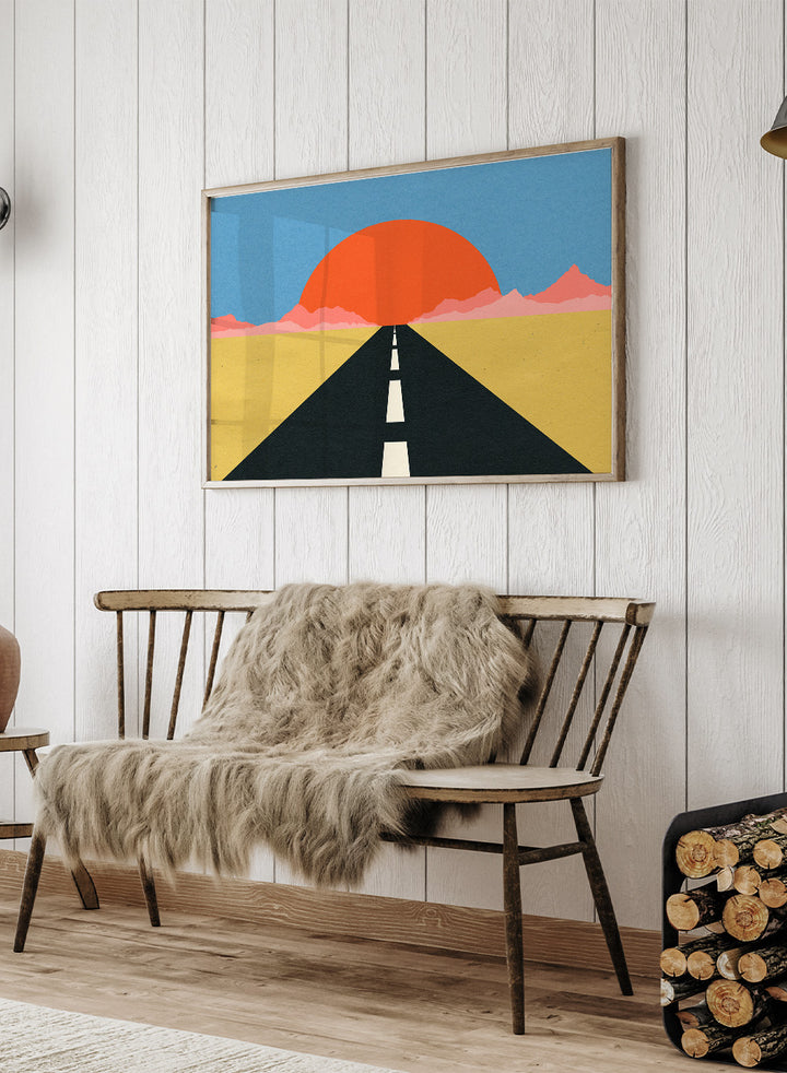 Simplified illustration of a road leading to a large red sun in a blue sky. Road To Sun by Rosi Feist is a modern landscape art print featuring a minimalist desert road, bold sunset colors, and contemporary graphic poster design.