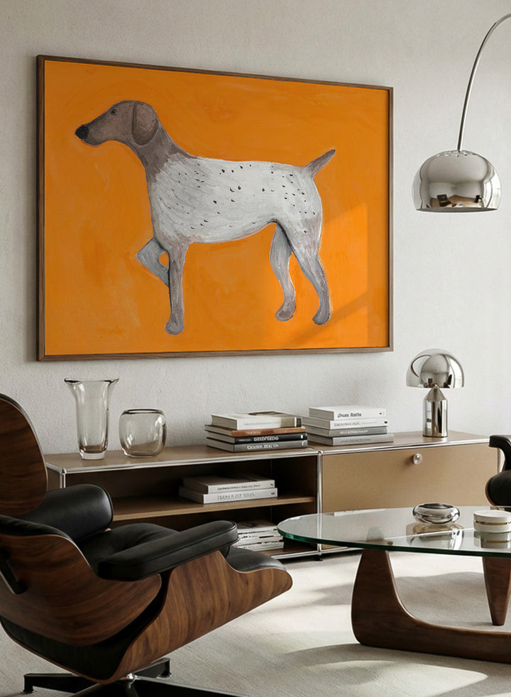 Framed artwork of a dog on an orange background. Orange Pointing Dog by Lerin Freyou is a hand painted minimal dog art print with bold orange background, modern animal poster with clean aesthetic style.