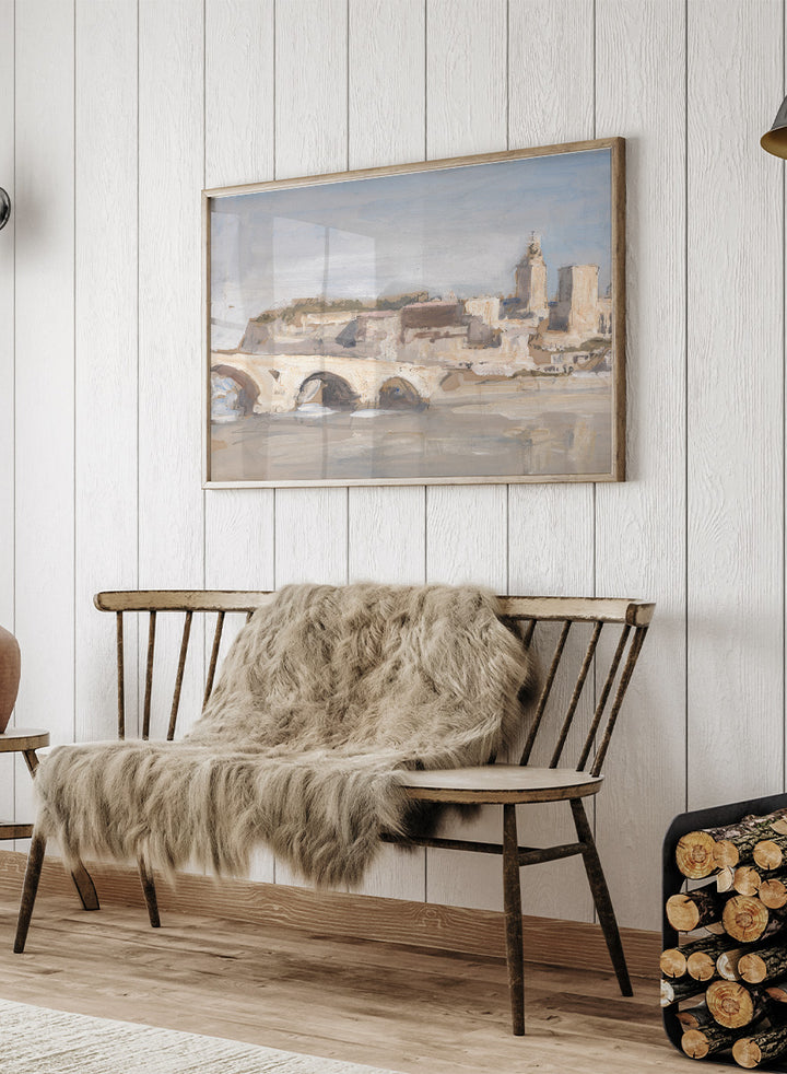 A framed art print depicting a scenic landscape with a stone bridge over water, historic buildings, and a church tower under a pale sky. Avignon; Bridge over a River by Hercules Brabazon Brabazon is a vintage watercolor art print featuring a stone bridge, river, and pale city skyline.