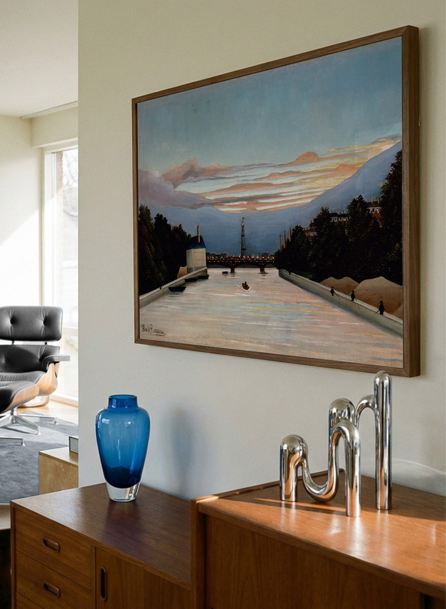 The Eiffel Tower by Henri Rousseau is a vintage Paris landscape art print featuring the Seine, Eiffel Tower, riverboats, city trees, and a blue sunset sky.