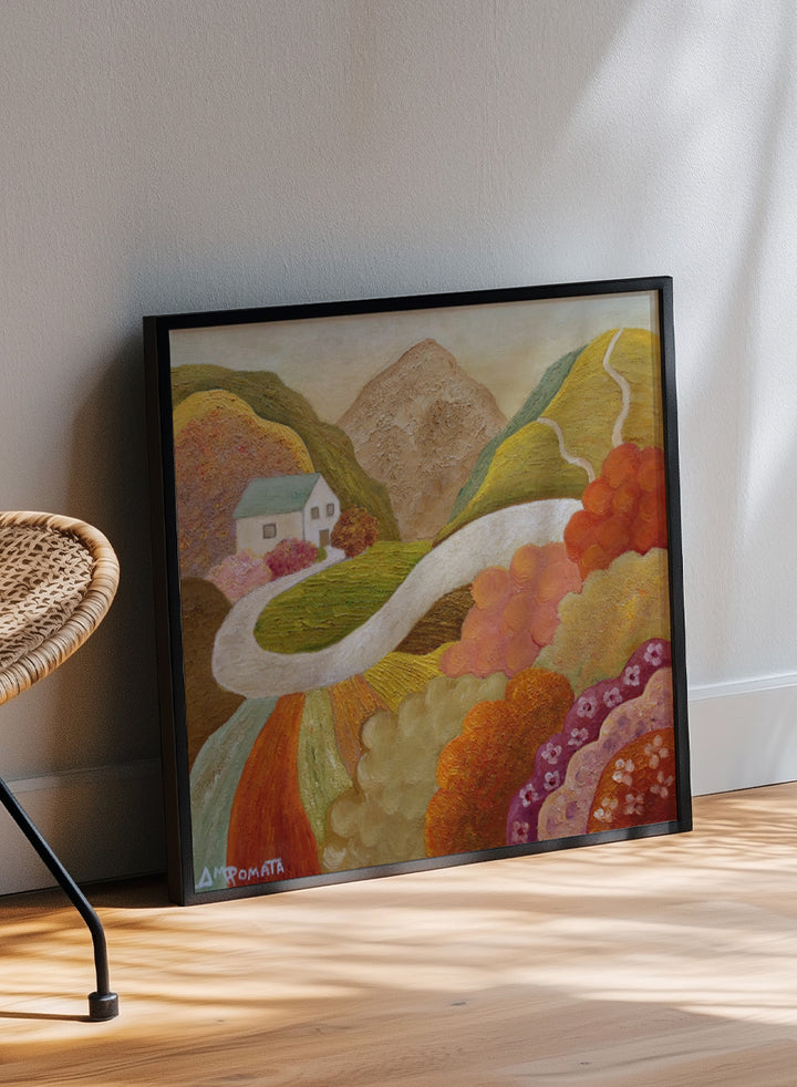 A framed landscape painting featuring a winding white road through colorful hills, a small white house, and a mountain in the background. Shop Colorful Hillside Home by Angeles M. Pomata, an autumn landscape art print featuring a winding road, white country house, rolling hills, and wildflowers.