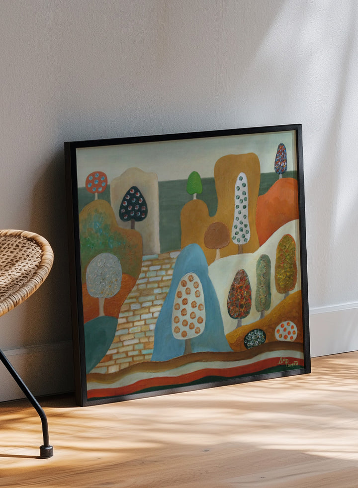 A framed abstract landscape painting featuring stylized trees, hills, and geometric forms in earthy tones of orange, blue, beige, green, and brown. Shop Whimsical Tree Landscape by Angeles M. Pomata, a colorful landscape art print featuring patterned trees, rounded hills, and a winding stone path.