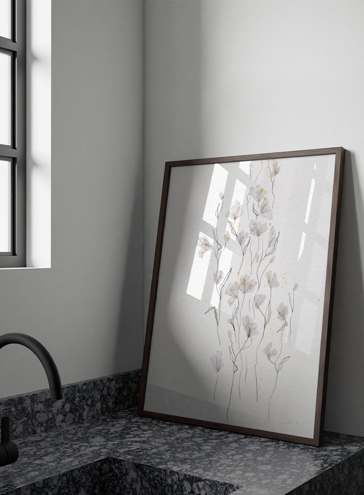 A framed watercolor painting of delicate white and light gray flowers with thin stems on a textured white background. Shop Delicate Gold Flowers by Ankie Kooi, a floral wall art print poster with airy botanical stems, soft gray flowers, yellow accents, and line art.