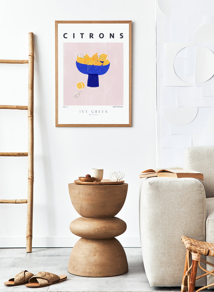 Illustration of lemons in a blue bowl on a pink background with 'Citrons' text and 'Ivy Green' branding. Citrons by Ivy Green lemon art print featuring bowl of lemons illustration, modern fruit poster design, and colorful contemporary kitchen wall art.
