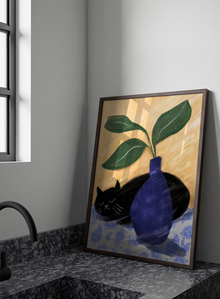 A stylized still life painting featuring a black cat lying on a blue-and-white patterned surface beside a dark blue vase with green leaves, against a warm beige background. Shop the Sleeping Black Cat art print by Dirkie Nell, featuring a curled black cat, bold cobalt blue vase, green leaves and playful patterned details.