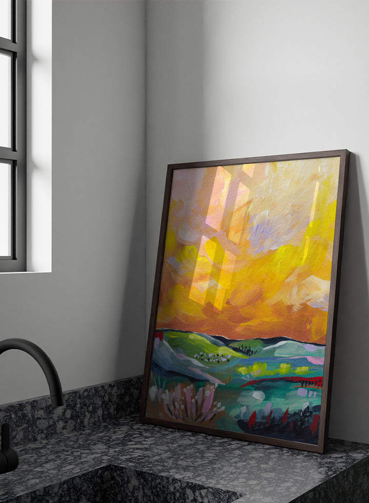 An abstract landscape painting featuring a dramatic yellow and orange sky over green and blue rolling hills, with textured brushstrokes. Shop Vibrant Sunset Landscape by Dirkie Nell, a colorful landscape art print featuring rolling green hills, wildflowers, and a warm golden sunset sky.