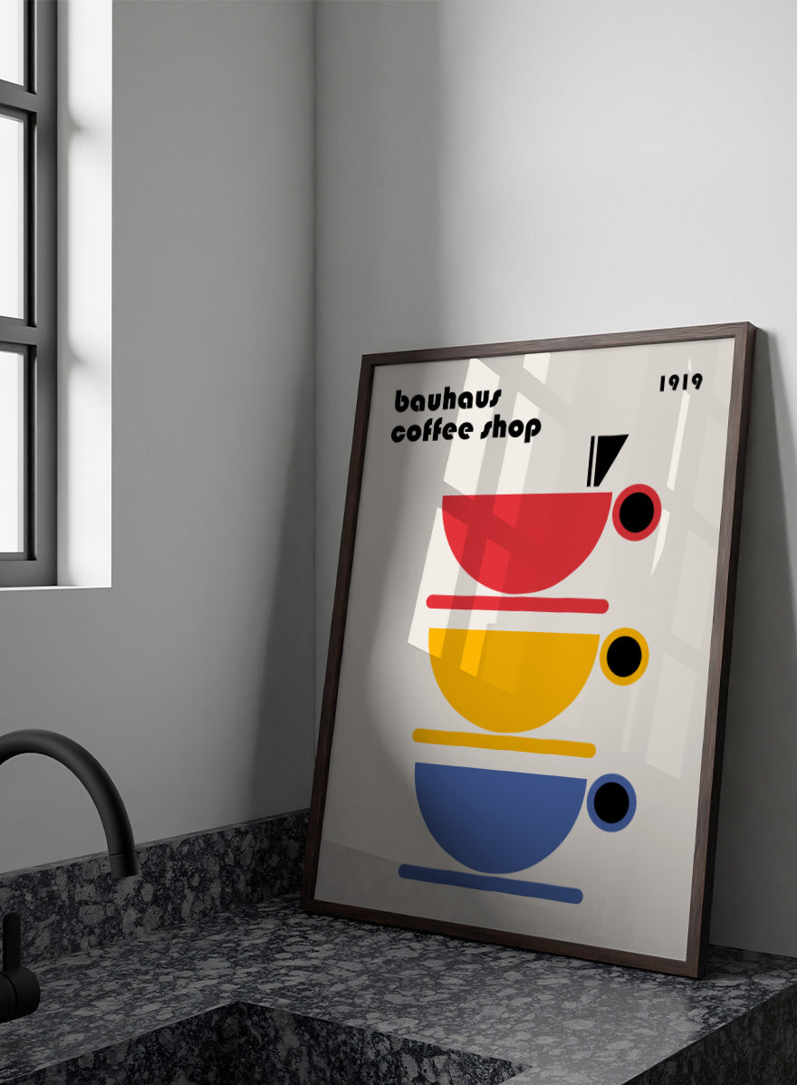 Bauhaus Coffee Cups by Retrodrome kitchen art print featuring stacked red, yellow, and blue coffee cups with bold Bauhaus-inspired design.
