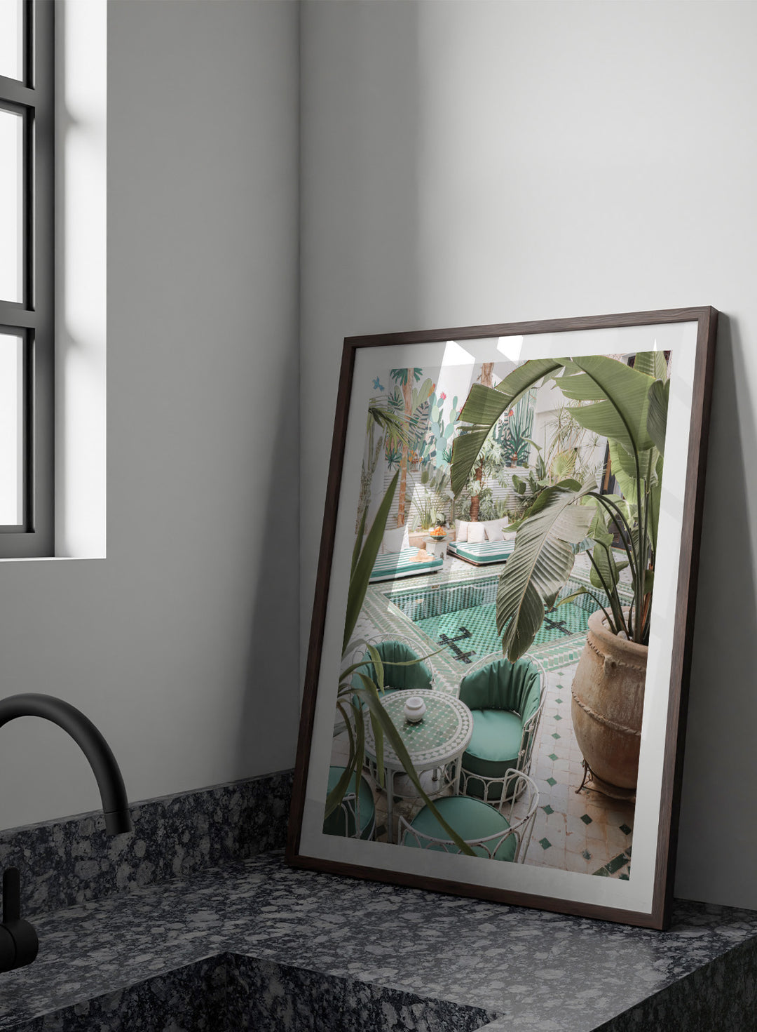 Outdoor patio with pool, green chairs, and potted plants. Green Courtyard Oasis by Henrike Schenk is a Morocco travel photography print showing a lush riad courtyard with green tilework, tropical plants, and poolside interiors.