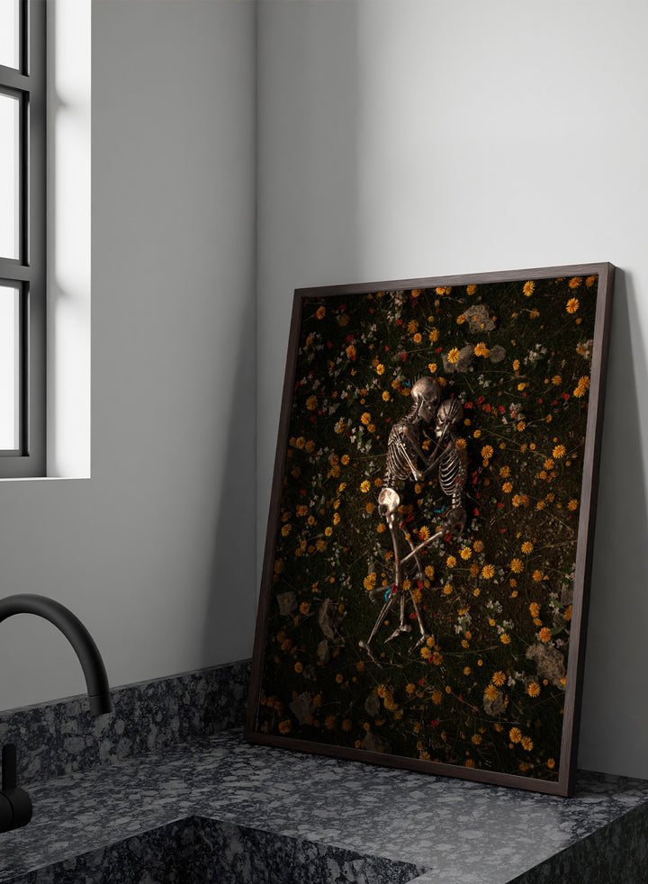 Skeletons In Love by Nicebleed is a surreal skeleton couple art print featuring intertwined skeletons in a floral field, modern aesthetic wall poster.