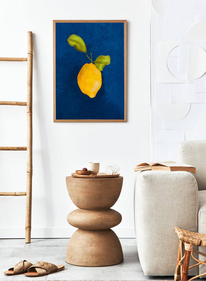Just a Little Lemon by Raissa Oltmanns is a modern lemon art print featuring a bold yellow citrus still life on deep blue wall poster design.