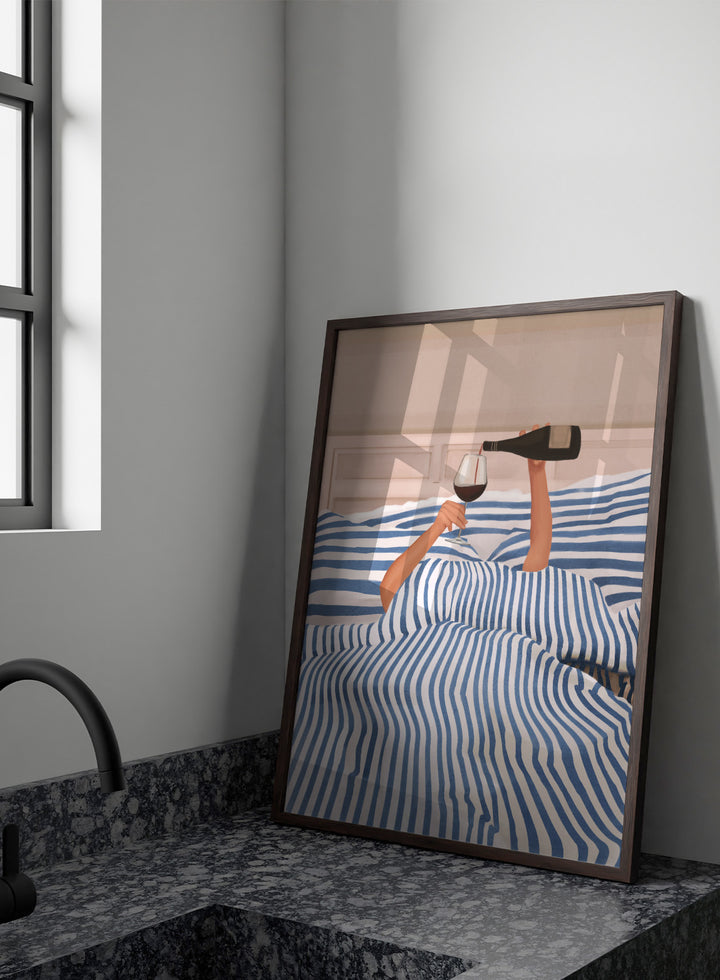 Person lying in bed pouring wine into a glass, wearing striped sheets. Wine In Bed by Flow Line is a playful art print featuring striped bedding, red wine, minimalist illustration, and cozy bedroom decor.