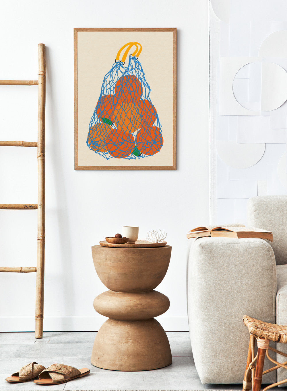 Blue mesh bag filled with orange fruits on a beige background. Oranges In a Net Bag by Rosi Feist is a modern minimalist fruit art print with bold color and Bauhaus-inspired graphic design. Officially licensed fine art poster with framing.
