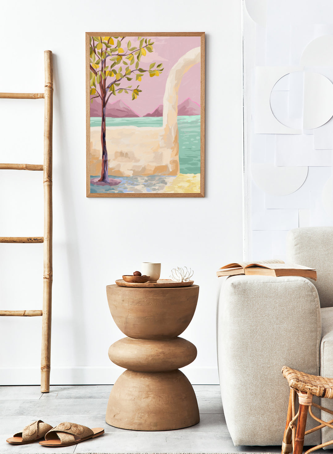 Artistic depiction of a tree by a lake with mountains in the background. Lemon Tree by Goed Blauw is a coastal art print and wall poster featuring a lemon tree, soft pastel sky, and ocean view in warm tones.