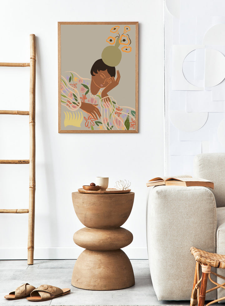 Illustration of a person with a flower on their head against a beige background. The Overthinker by Arty Guava is a modern woman illustration art print with soft florals and warm tones. Officially licensed wall poster with framing.