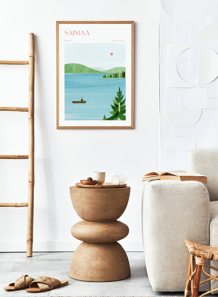 Illustration of a lake scene with a person fishing, surrounded by greenery and mountains, with 'Saimaa, Finland' text at the top. Calm Saimaa Lake Fishing by Longwayhome is a minimalist Scandinavian landscape art print featuring peaceful Finland lake scenery, forest views, and modern Nordic design.