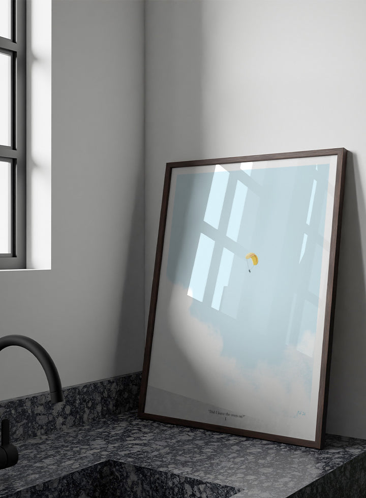 A minimalist art print featuring a light blue sky with white clouds and a small yellow-and-white parachute near the center, framed by a black border with the quote &