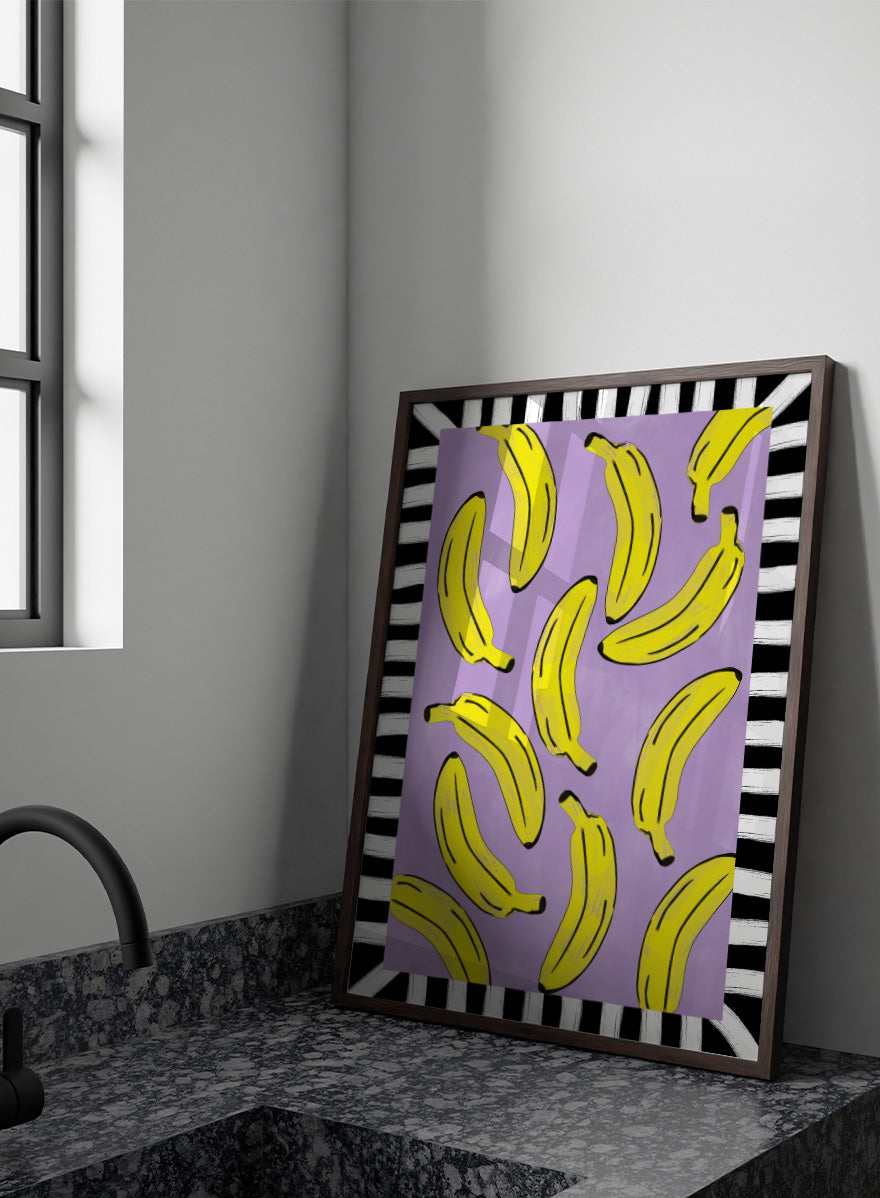 Shop Playful Banana Scatter by Elena Ristova, a banana wall art print poster in yellow, purple, black, and white with a bold striped border.