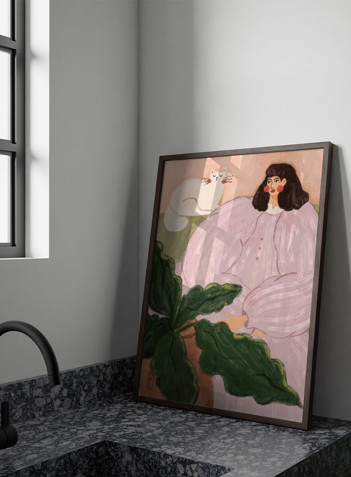 A stylized painting of a woman in a pale pink striped dress seated beside a white cat, with large green leaves in the foreground and a peach background. Cozy Woman With Cat by Dirkie Nell is a colorful portrait and animal art print featuring a woman in lavender, a white cat, oversized leaves, and soft pink tones.