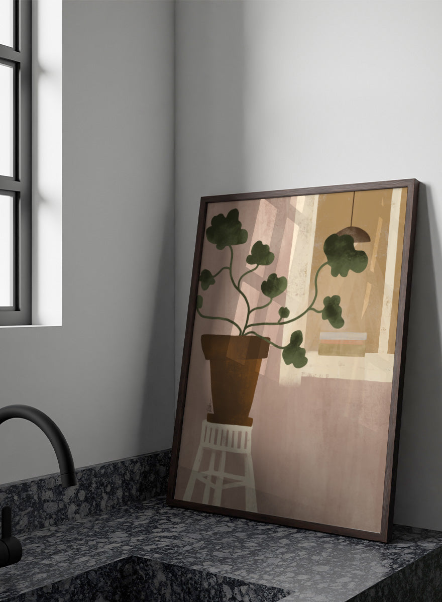A minimalist art print depicting a potted green plant on a white stool against a dusty pink wall, with a window and hanging lamp in the background. Shop Cozy Houseplant Window by Elsa Nätterdal, a modern botanical interior art print featuring a leafy plant, soft neutral tones, and a cozy home setting.