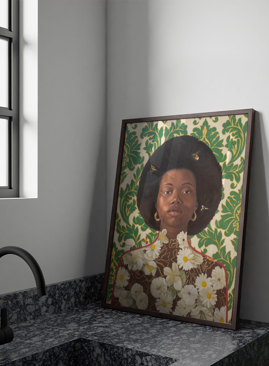 A stylized portrait artwork of a Black woman with an afro hairstyle, wearing gold hoop earrings and a brown top covered in white daisy flowers, set against a green and cream damask patterned background with small bees visible. Shop Afro Floral Portrait by Damilare Jamiu, a contemporary portrait wall art print featuring a woman with afro hair, floral details, bees, and rich green tones.