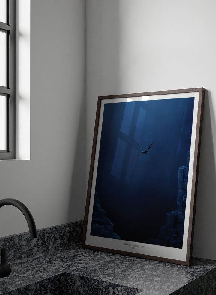 A framed art print featuring a dark blue underwater scene with a diver floating in the center, flanked by glowing blue rock formations. Shop Deep Blue Diver by Jake Waldron, a minimalist diving wall art print featuring a lone deep-sea diver, underwater cliffs, and dramatic navy blue tones.
