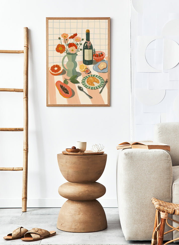 A stylized still life illustration showing a bottle, flowers in a pitcher, fruit, bread, and tableware on a striped surface against a grid background. Colorful Breakfast Still Life by Katarzyna Gąsiorowska art print featuring fruit, flowers, a croissant, and colorful kitchen tableware in soft modern tones.