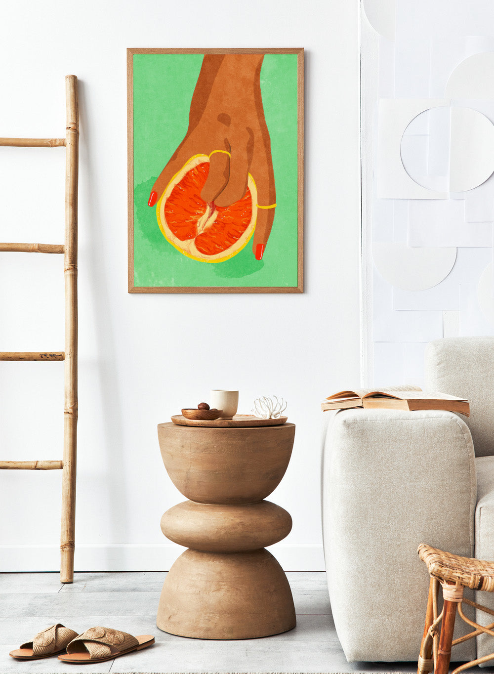 Illustration of a hand holding a sliced orange against a green background. Fruit Lover wall art print by Raissa Oltmanns blends playful citrus and intimate symbolism in a contemporary modern aesthetic poster.