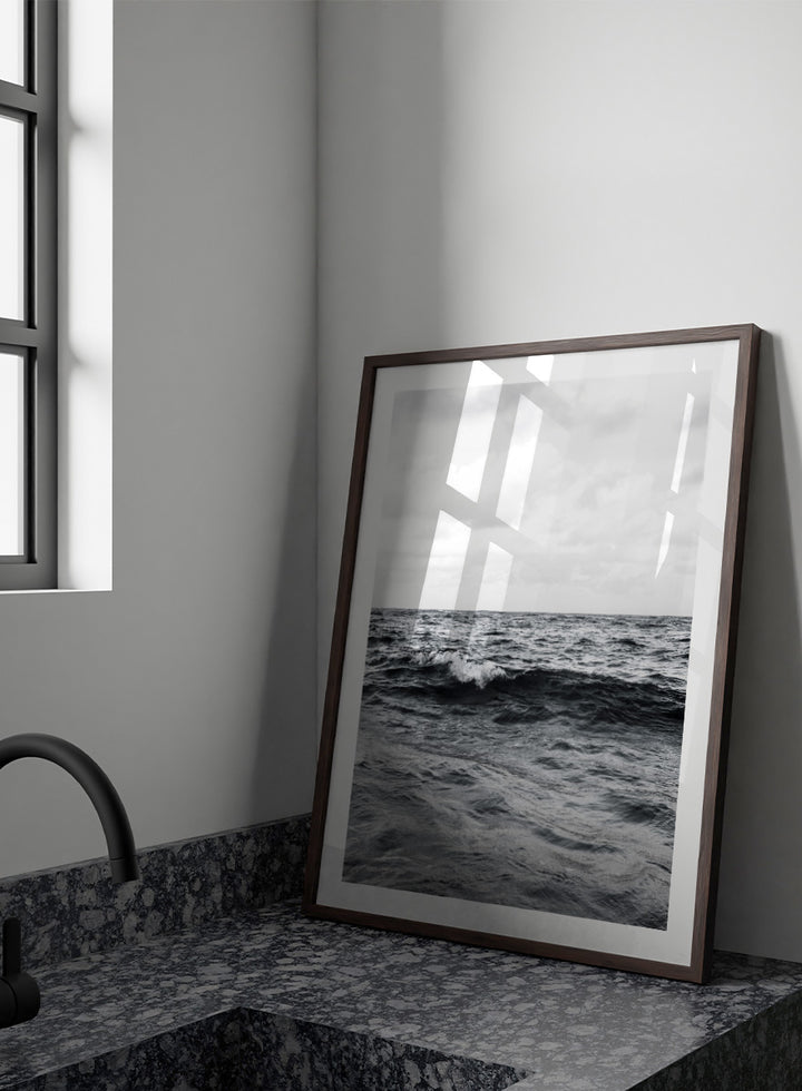 Black and white photographic art print of ocean waves under a cloudy sky. Endless Waves by Shot by Clint black-and-white ocean photography print featuring rolling water, textured surf, cloudy skies, and dramatic coastal movement.