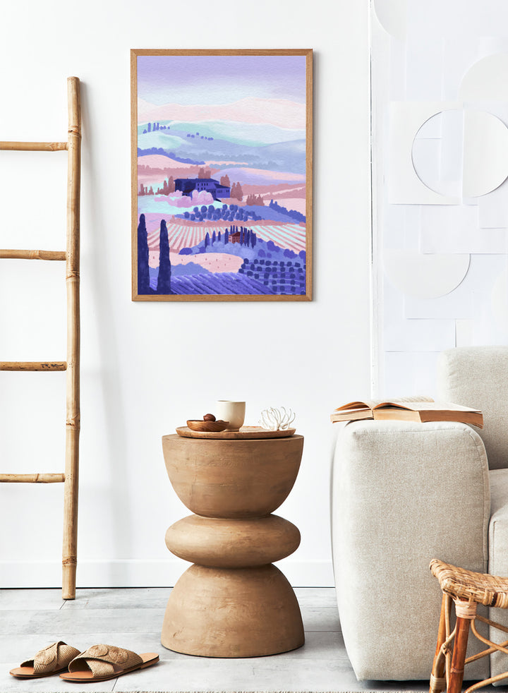Painting of a landscape with rolling hills, buildings, and cypress trees in pastel colors. Tuscany by Goed Blauw is a landscape art print and wall poster featuring rolling hills, fields, and countryside homes in soft pastel tones.
